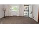 Inviting living room with carpet flooring, curtains, and a large window providing ample light at 2220 Radcliffe Ave, Indianapolis, IN 46227