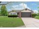 Charming single-story home featuring a two-car garage, manicured lawn, and inviting curb appeal at 308 Creekstone Ct, Indianapolis, IN 46239