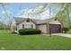 A single-story home boasts a well-maintained lawn and an attached two-car garage, showcasing suburban charm at 308 Creekstone Ct, Indianapolis, IN 46239