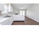 Modern kitchen featuring clean white cabinets, and views into a living area with a fireplace and backyard doors at 308 Creekstone Ct, Indianapolis, IN 46239