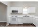 Bright kitchen showcasing white cabinets, modern appliances, and ample countertop space at 308 Creekstone Ct, Indianapolis, IN 46239