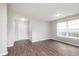 Open-concept space with new flooring, and neutral paint, illuminated by natural light from a window at 308 Creekstone Ct, Indianapolis, IN 46239