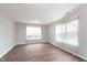 Minimalist living room featuring hardwood-style floors, bright walls, and large windows for natural light at 308 Creekstone Ct, Indianapolis, IN 46239