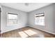 Bright bedroom with hardwood floors, complemented by neutral walls and two windows at 333 N Jefferson St, Brownsburg, IN 46112