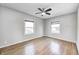 Comfortable bedroom with hardwood floors, a ceiling fan, and bright natural lighting at 333 N Jefferson St, Brownsburg, IN 46112
