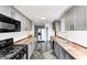 Updated kitchen with gray cabinets, modern appliances, and stylish backsplash at 333 N Jefferson St, Brownsburg, IN 46112