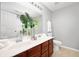 Well-lit bathroom with double vanity, modern fixtures, and a decorative vase with greenery at 3546 Golden Gate N Dr, Carmel, IN 46074
