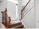 Bright entryway with hardwood stairs, a white door, and a decorative table at 3546 Golden Gate N Dr, Carmel, IN 46074