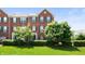Attractive brick townhouse with green shutters and lush landscaping on a sunny day at 3546 Golden Gate N Dr, Carmel, IN 46074