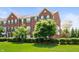 Charming brick townhouse featuring a well-manicured lawn and tasteful green shutters at 3546 Golden Gate N Dr, Carmel, IN 46074