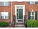 Inviting brick home featuring an elegant front door with decorative trim and green shutters at 3546 Golden Gate N Dr, Carmel, IN 46074