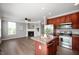 Open-concept design with a kitchen flowing into a living space, stainless steel appliances, and an island at 3546 Golden Gate N Dr, Carmel, IN 46074
