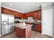 Modern kitchen featuring stainless steel appliances, a central island, and sleek wooden cabinetry at 3546 Golden Gate N Dr, Carmel, IN 46074