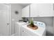 Functional laundry room with white cabinets and modern appliances for efficient chores at 3546 Golden Gate N Dr, Carmel, IN 46074