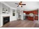 Open concept living room boasts a fireplace, hardwood floors, and seamless flow into the kitchen area at 3546 Golden Gate N Dr, Carmel, IN 46074