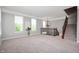 Open-concept living room with carpet, large windows, and a decorative chandelier at 3546 Golden Gate N Dr, Carmel, IN 46074
