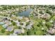 An aerial view shows the neighborhood, homes, and a lake at 3601 Lakeshore Ct, Greenwood, IN 46143