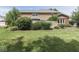 Well-manicured lawn in a spacious backyard featuring mature trees and decorative landscaping at 3601 Lakeshore Ct, Greenwood, IN 46143