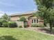 View of the backyard showing the home's exterior, brick facade, and lush green lawn at 3601 Lakeshore Ct, Greenwood, IN 46143