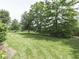 Expansive, well-maintained backyard with lush greenery and mature trees providing privacy at 3601 Lakeshore Ct, Greenwood, IN 46143