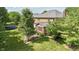 Aerial view of the property highlighting the expansive backyard with a brick extension and mature trees at 3601 Lakeshore Ct, Greenwood, IN 46143