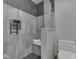 Modern tiled shower stall features a built-in bench, matte black hardware, and a frosted glass door at 3601 Lakeshore Ct, Greenwood, IN 46143