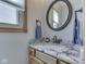 Bathroom featuring a granite countertop, a framed circular mirror, and framed window at 3601 Lakeshore Ct, Greenwood, IN 46143