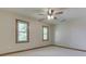Bedroom featuring neutral carpet, natural colored trim, and two windows at 3601 Lakeshore Ct, Greenwood, IN 46143