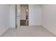View of an open bedroom doorway with white trim, carpet, and neutral-colored walls at 3601 Lakeshore Ct, Greenwood, IN 46143