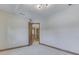 Bedroom featuring neutral carpet and trim with a view into the hallway at 3601 Lakeshore Ct, Greenwood, IN 46143
