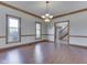 Traditional dining room featuring hardwood floors, wood trim, and an elegant chandelier at 3601 Lakeshore Ct, Greenwood, IN 46143