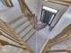 This foyer features carpeted stairs with wooden handrail and spindles, as well as a dark front door at 3601 Lakeshore Ct, Greenwood, IN 46143