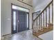 Open foyer featuring tile floors, a wood staircase, and transom window over the front door at 3601 Lakeshore Ct, Greenwood, IN 46143