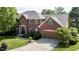 Exterior view of a stately brick home with a well-manicured lawn and a two-car garage at 3601 Lakeshore Ct, Greenwood, IN 46143