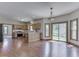 Open eat-in kitchen with hardwood floor, wooden cabinets, stainless steel appliances, and sliding glass door at 3601 Lakeshore Ct, Greenwood, IN 46143
