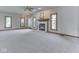 Expansive living room with neutral carpeting, a charming fireplace, and large windows at 3601 Lakeshore Ct, Greenwood, IN 46143
