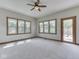 Bright living room with neutral walls, carpeted floor, ceiling fan and windows allowing ample natural light at 3601 Lakeshore Ct, Greenwood, IN 46143