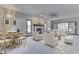 Stylishly staged living room with fireplace, plush seating, and a dining table with seating at 3601 Lakeshore Ct, Greenwood, IN 46143