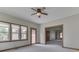 Bright living room with neutral walls, carpeted floor and windows with wood trim allowing ample natural light at 3601 Lakeshore Ct, Greenwood, IN 46143