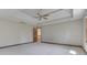This main bedroom features a large window, neutral walls, neutral carpet, and a ceiling fan at 3601 Lakeshore Ct, Greenwood, IN 46143