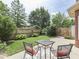 Patio with a table and chairs, surrounded by manicured greenery and a privacy fence at 3601 Lakeshore Ct, Greenwood, IN 46143