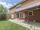 Back patio area with a dining set, sliding glass doors, and a retractable awning at 3601 Lakeshore Ct, Greenwood, IN 46143