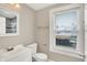 Bright bathroom featuring vanity sink, toilet, and window at 364 Congress Ave, Indianapolis, IN 46208