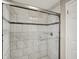Bathroom featuring marble-tiled shower with sliding glass door at 364 Congress Ave, Indianapolis, IN 46208
