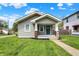 Charming home with a gray exterior, covered front porch, and well-maintained lawn, creating a welcoming curb appeal at 364 Congress Ave, Indianapolis, IN 46208