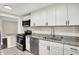Updated kitchen featuring white cabinets, granite countertops, and stainless steel appliances at 364 Congress Ave, Indianapolis, IN 46208