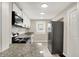 Modern kitchen featuring granite countertops, stainless steel appliances, white cabinets, and a gray tile floor at 364 Congress Ave, Indianapolis, IN 46208