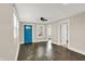 Bright living room with hardwood floors, natural light, a ceiling fan, and a vibrant blue front door at 364 Congress Ave, Indianapolis, IN 46208