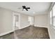Open living room featuring hardwood floors, natural light, a ceiling fan, and access to other rooms at 364 Congress Ave, Indianapolis, IN 46208