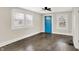 Bright living room with hardwood floors, natural light, a ceiling fan, and a vibrant blue front door at 364 Congress Ave, Indianapolis, IN 46208